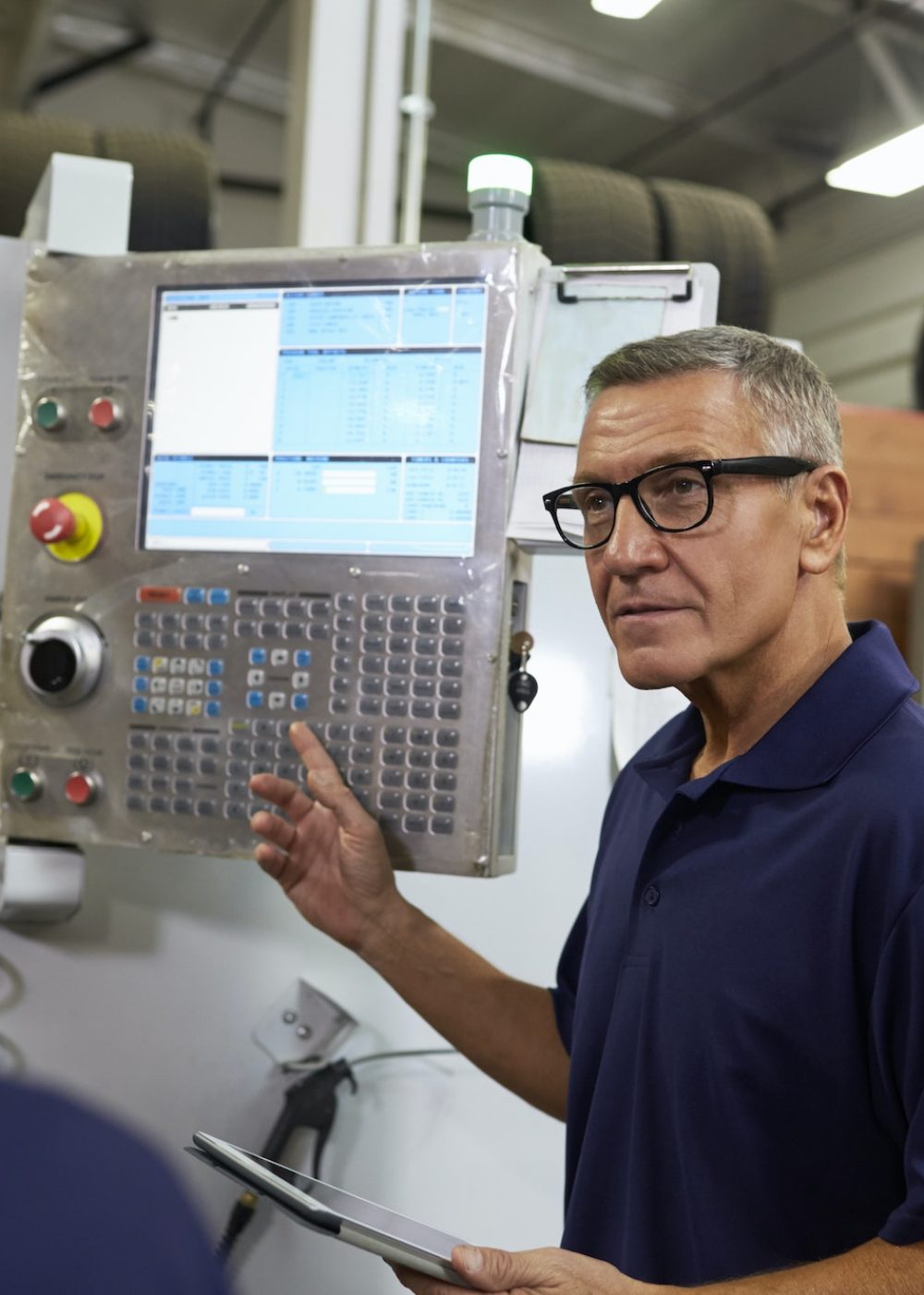 Engineer Training Apprentices On CNC Machine